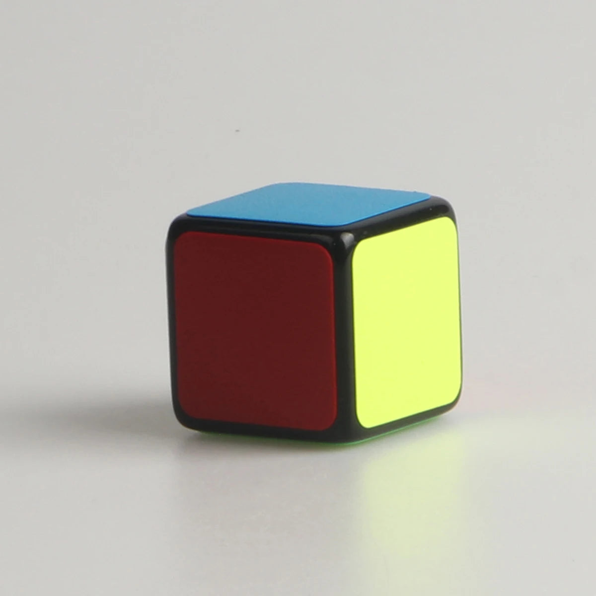 1x1 Mini Magic Cube with red, yellow, and blue faces on a white background